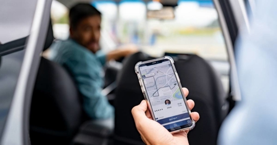 Man getting into a car he requested using a mobile app