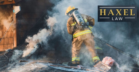 firefighter entering building with black smoke