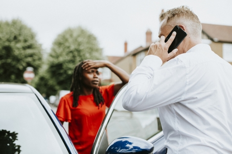 Man calling an insurance after a car accident.